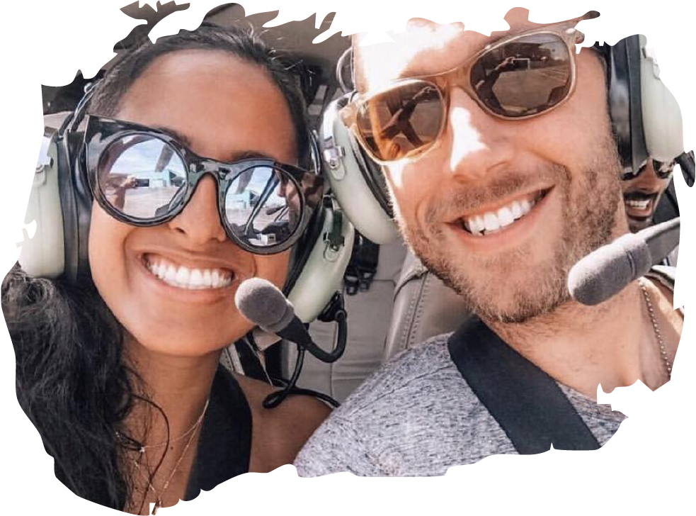 Two people in a helicopter cockpit.