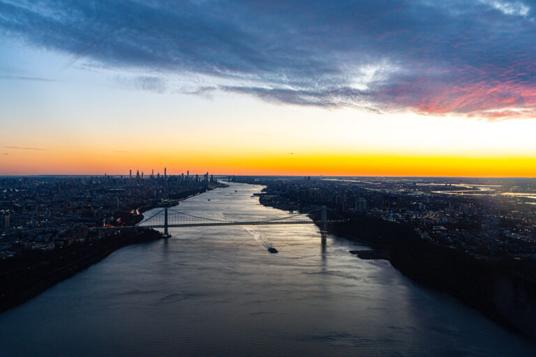 Sunset over city skyline and river