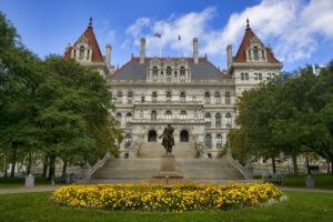 New York State Capitol with statue and flowers