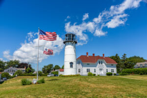 Lighthouse of Chatham with American flags and greenery