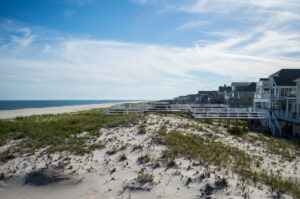 Coastal homes beside sandy beach and ocean